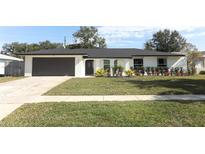 Newly renovated single-story home featuring a modern facade and landscaped lawn at 1552 East Blvd, Maitland, FL 32751