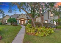Stunning home featuring lush landscaping, a manicured lawn, and a grand entrance with charming architectural details at 278 Eaglet Way, Lake Mary, FL 32746