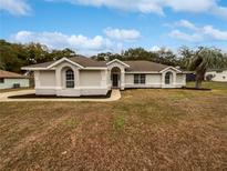 Single-story home with a landscaped yard and attached garage at 5803 Sw 107Th St, Ocala, FL 34476