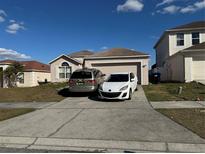 Two-car driveway and a charming house with a well-maintained lawn at 6868 Westlake Blvd, Orlando, FL 32810