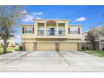 A beautiful two-story home with a three-car garage and a charming front balcony with dark iron railing at 1604 Scarlet Oak Loop # B, Winter Garden, FL 34787