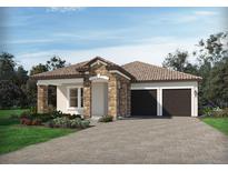 One-story home with stone accents, tile roof, and two-car garage at 16444 Silver Grove, Winter Garden, FL 34787