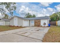 Charming single-story home featuring a stone accent wall and well-maintained front yard at 2235 Ginger Way, Lakeland, FL 33801