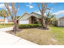 House exterior with a two car garage and landscaping at 3131 Ash Park Loop, Winter Park, FL 32792