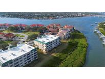 Aerial view of waterfront condo community with lush landscaping and boat slips at 432 Bouchelle Dr # 102, New Smyrna Beach, FL 32169