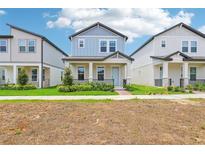 Charming two-story home with a covered front porch and beautifully landscaped front yard at 5003 Railroad Vine Aly, Winter Garden, FL 34787
