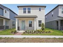 Charming two-story home features a welcoming front porch and well-maintained landscaping at 5087 Railroad Vine Aly, Winter Garden, FL 34787