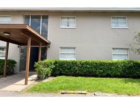 Two-story apartment complex with gray brick and well-manicured green hedges at 5885 Dahlia Dr # 24, Orlando, FL 32807