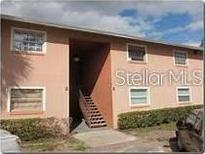 Tan colored two-story building with stairs leading to the entrance at 5885 Dahlia Dr # 24, Orlando, FL 32807