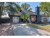 Charming one-story home with a concrete driveway and a dark blue exterior at 1254 Seminola Blvd, Casselberry, FL 32707
