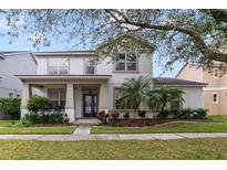 Two-story house with a landscaped lawn and front porch at 2556 Antlia Dr, Orlando, FL 32828