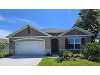 Charming single-story home with well-maintained landscaping, attached garage and neutral color palette at 2798 Portadown St, Ormond Beach, FL 32174