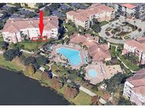 Aerial view of condo community, pool, and landscaping at 5012 Shoreway Loop # 10207, Orlando, FL 32819