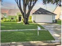 Single-story house with attached garage and well-maintained lawn at 7808 Rollingridge Ct, Orlando, FL 32835