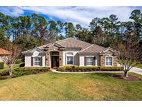 Single-story home with tile roof, stone accents, and lush landscaping at 1458 Foxtail Dr, Lake Mary, FL 32746