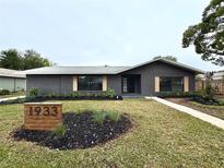 Updated home exterior boasts a fresh coat of paint and landscaping at 1933 Winnebago Trl, Fern Park, FL 32730