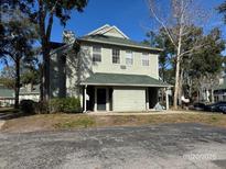 Two-story condo building with parking and landscaping at 6034 Westgate Dr # 202, Orlando, FL 32835