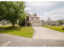 Charming two-story home featuring an attached two-car garage and well-maintained lawn at 1010 Embrun Ct, Kissimmee, FL 34759