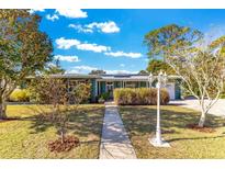 Charming ranch home with landscaped yard and walkway at 1296 W Wellington Dr, Deltona, FL 32725