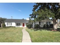 Ranch style home with red door, walkway, and mature landscaping at 2201 Sunderland Rd, Maitland, FL 32751