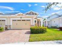 Charming home featuring a manicured lawn, brick driveway, and neutral stucco exterior at 2507 Yellow Brick Rd, St Cloud, FL 34772