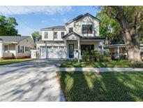 Charming two-story home featuring a manicured lawn, a two-car garage, and a welcoming blue front door at 2510 Amherst Ave, Orlando, FL 32804