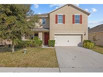 Two-story house with a two-car garage and landscaped lawn at 3666 Maidencain St, Clermont, FL 34714