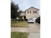 Two-story house with attached garage and a well-maintained lawn at 3666 Maidencain St, Clermont, FL 34714