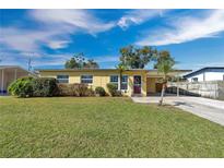 Charming single-story home features a well-maintained lawn, covered carport, and a welcoming front entrance at 4806 Hollyberry Dr, Orlando, FL 32812