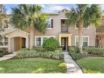 Two-story townhome with attractive landscaping and a welcoming front porch at 8757 Via Tavoleria Way, Windermere, FL 34786