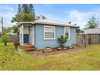 Charming blue house with a landscaped yard and brick walkway at 922 Wyoming Ave, St Cloud, FL 34769