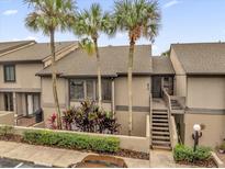 Exterior view of condo building with palm trees and walkway at 670 Lake Villas Dr # D, Altamonte Springs, FL 32701