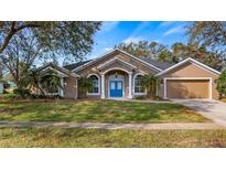 Attractive one-story home with a two-car garage and landscaped lawn at 8835 Spyglass Loop, Clermont, FL 34711