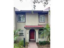 Inviting two-story townhome with red door and landscaping at 1007 Baseball And Boardwalk Ct, Kissimmee, FL 34746