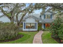 Two-story house with blue siding, brick pathway, and lush landscaping at 1105 Superior Ct, Winter Springs, FL 32708