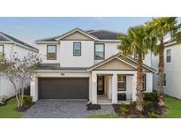 Two-story house with gray roof, white walls, and a two-car garage at 2628 Calistoga Ave, Kissimmee, FL 34741