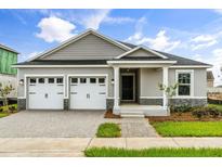 Charming single-story home featuring a two-car garage and a beautifully landscaped front yard at 341 Sunbrooke Dr, Groveland, FL 34736