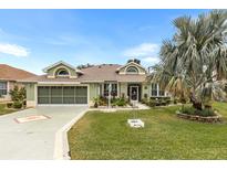 Attractive single-story house with a two-car garage and landscaped front yard at 3566 Tropical Seas Loop, Tavares, FL 32778