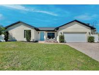 Charming single-story home with a well-manicured lawn and a welcoming sky-blue front door at 1003 Beckstrom Dr, Oviedo, FL 32765