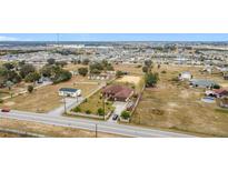 Aerial view of a house with surrounding land and other houses at 1719 North W Blvd, Davenport, FL 33837