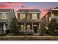 Two-story house with a brown door and front porch at 8468 Powder Ridge Trl, Windermere, FL 34786