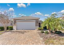 Single-story home with a two-car garage and paved driveway at 161 Old Moss Cir, Deland, FL 32724