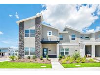 Modern two-story home with gray exterior and landscaping at 4299 Paragraph Dr, Kissimmee, FL 34746