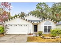 Single-story house with attached garage and landscaped yard at 4382 Weeping Willow Cir, Casselberry, FL 32707