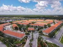 Aerial view of a community with townhouses, pool, and tennis court at 4766 Coral Castle Dr, Kissimmee, FL 34746