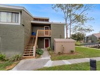 Exterior view of condo with stairs, private entrance, and storage unit at 5896 Peregrine Ave # C01, Orlando, FL 32819