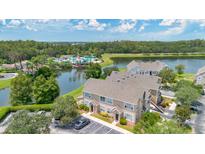 Aerial view of a townhome community near a lake at 8981 Lee Vista Blvd # 2209, Orlando, FL 32829