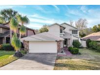 Two-story house with brick accents and a large driveway at 282 S Fox Chase Pt, Longwood, FL 32779