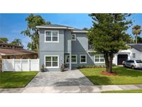 Modern two-story house with gray siding, paver driveway, and landscaped lawn at 1875 Staunton Ave, Winter Park, FL 32789