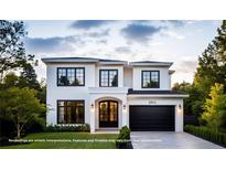 Elegant two-story home featuring a black garage door, black trim, and manicured lawn at 2011 University Dr, Orlando, FL 32804